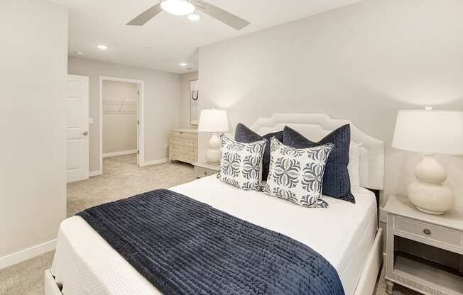 a bedroom with a large bed and a ceiling fan at The Azul Apartment Homes, Oxford, Mississippi