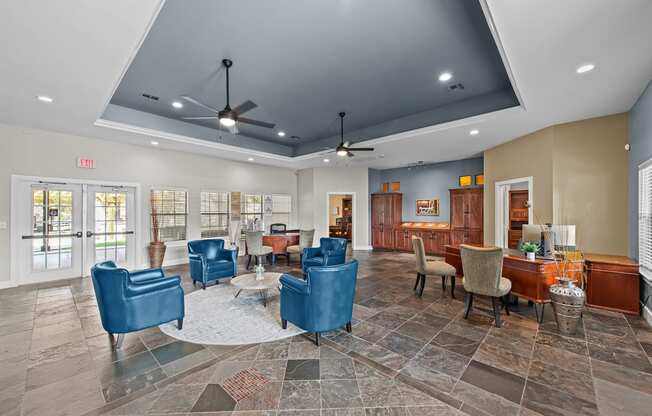 a lobby with blue chairs and tables and a bar