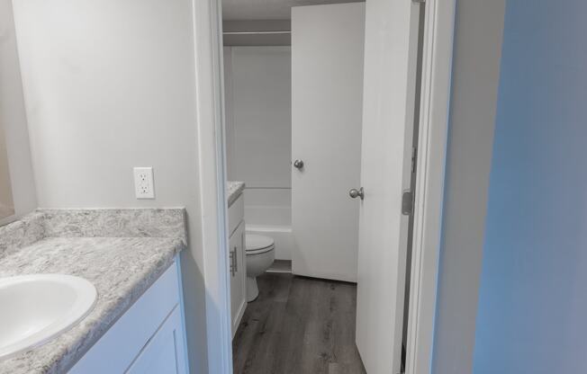 an empty bathroom with a sink and a toilet in it