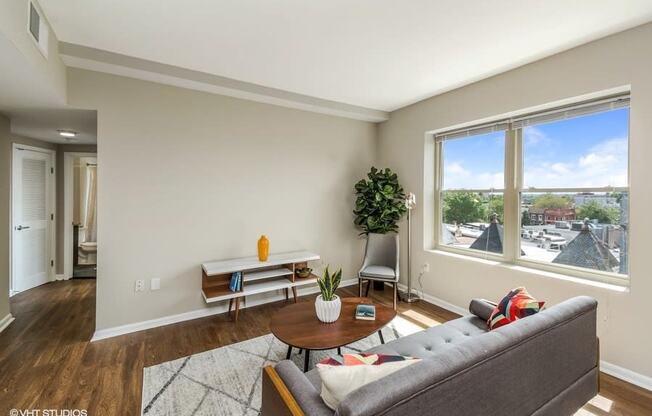 a living room with a large window and a couch