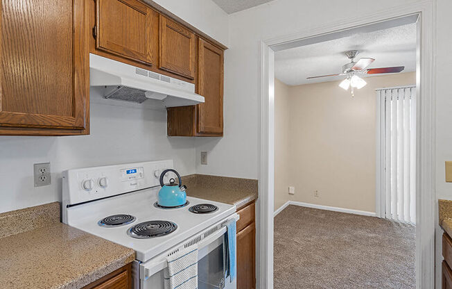 a kitchen with a stove and a kettle on the stove