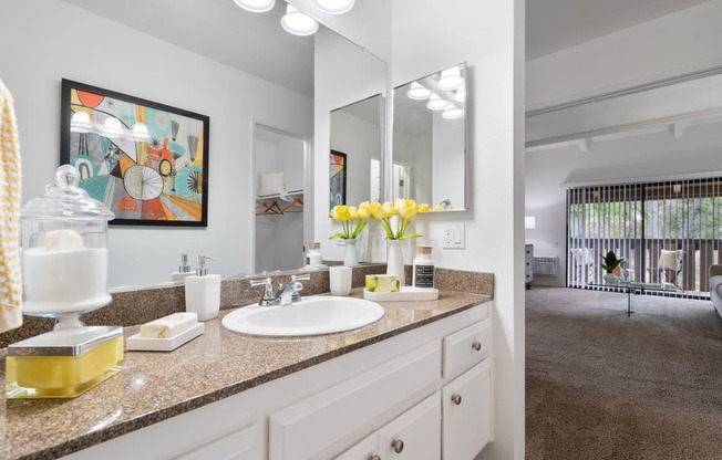 a white bathroom with a sink and a mirror