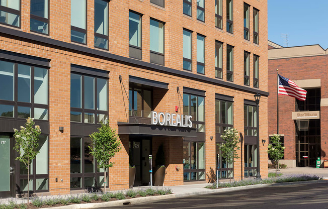 A Borelis storefront with a brick facade and an American flag.