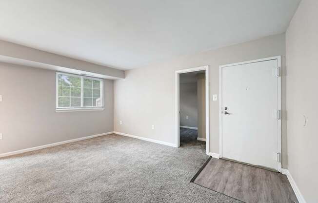 an empty room with carpet and a door at ReNew Odenton