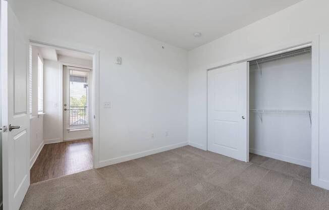 A room with white walls and a carpeted floor.