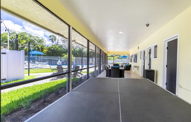 A long hallway with a black floor and white walls.