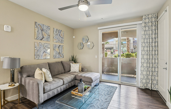 View of Living Room and Sliding Glass Door Leading to Shaded Patio