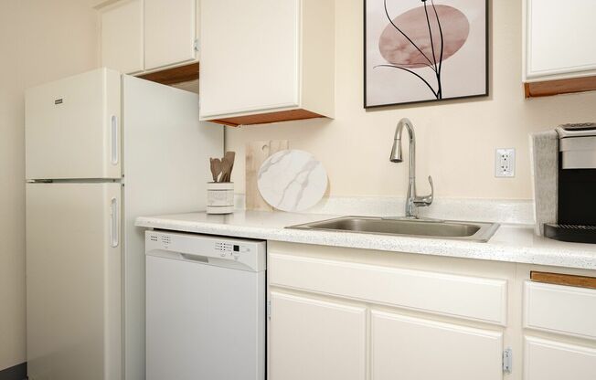 A white fridge and dishwasher in a kitchen.