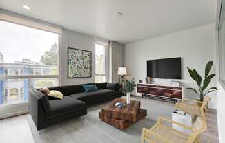 a living room filled with furniture and a large window