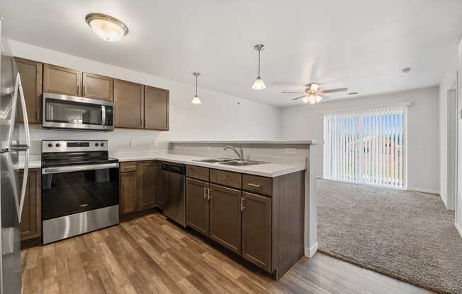 a kitchen with wooden cabinets and stainless steel appliances