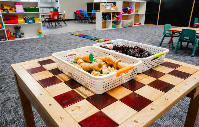 A table with a checkerboard pattern and two baskets of food on it at Sutton Hill Apartments, Des Moines