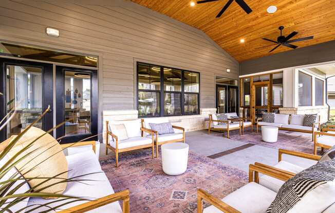 Covered patio with furniture and a ceiling fan at The Parker Austin, Pflugerville, Texas