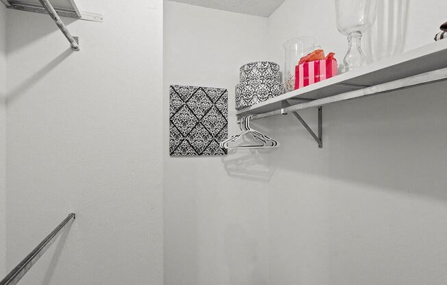 a white bathroom with a shelf in the wall