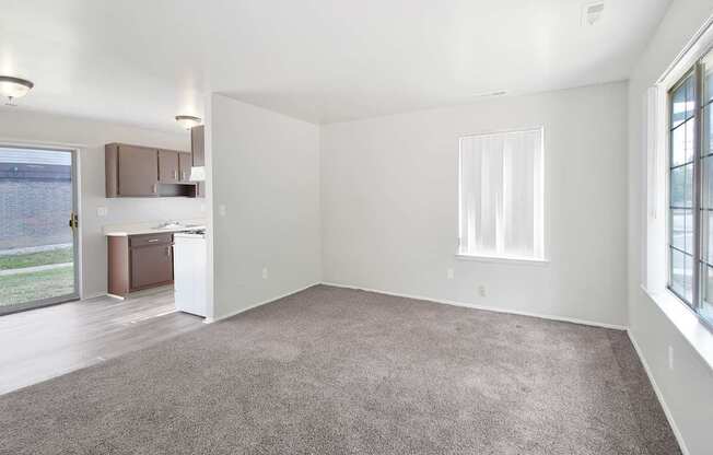 Open-concept living room with dining area and kitchen at Farmbrooke Manor Clinton Township MI