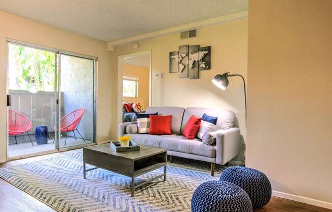 a living room with a couch and a coffee table and a sliding glass door