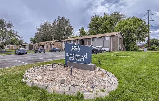 the roundabout apartments sign in front of a parking lot