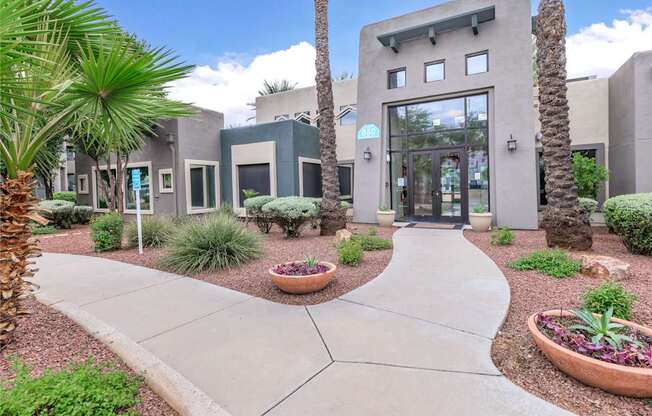 A modern building with a concrete walkway in front.