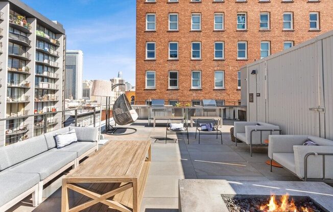 Rooftop lounge space with fire pit at TL Residences