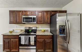 a kitchen with stainless steel appliances and wooden cabinets