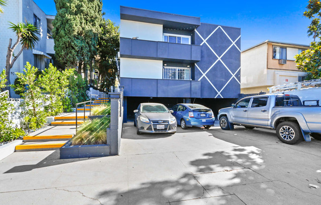 a blue and white building with cars parked in front of it