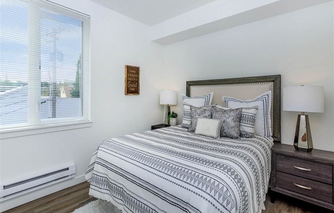 a bedroom with a bed next to a window at Jefferson Yards, Tacoma