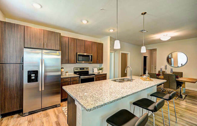 a kitchen with a large counter top next to a refrigerator at Luxor Club, Jacksonville, FL, 32258