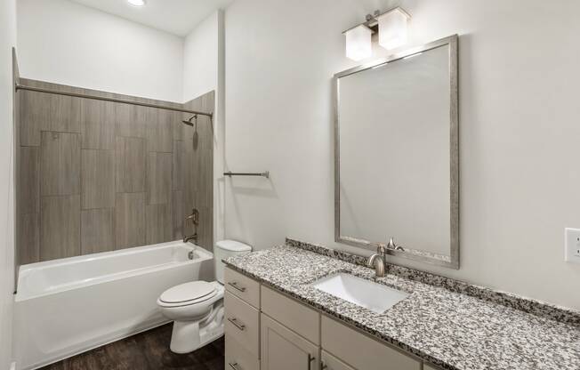 the preserve at ballantyne commons community bathroom with granite counter top and shower and
