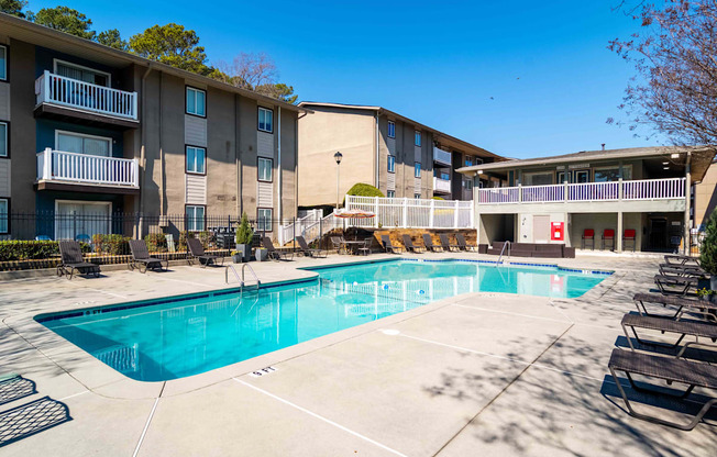 Swimming pool with sundeck and seating in community-oriented Atlanta apartments