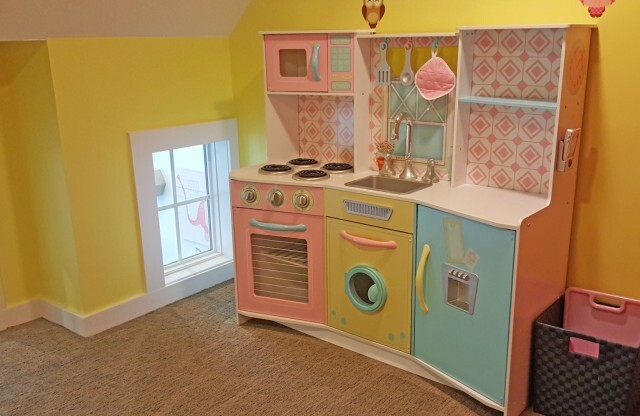 Inside of playroom showing play kitchen