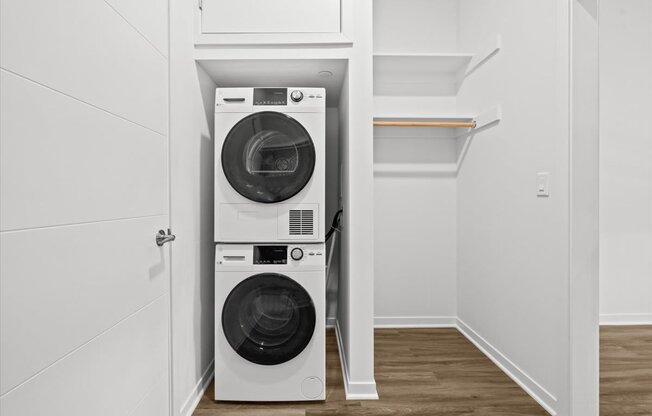 A white washing machine and dryer in a small laundry room.