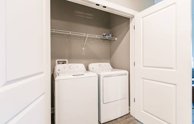 a washer and dryer in a laundry room with white doors