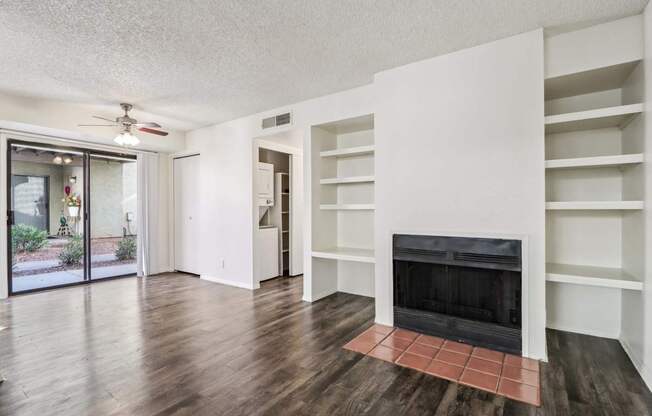 A living room with a fireplace and a sliding glass door.