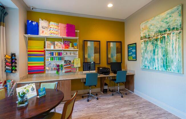 a home office with two computers and a table