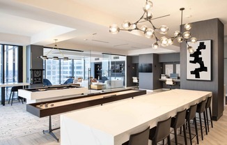 a communal table with a shuffleboard and foosball table at 220 Meridian, Indianapolis, IN 46204