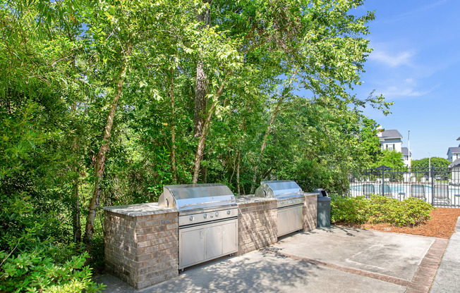 A tree-lined driveway leads to a house with a garage.