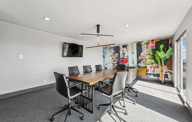 A conference room with a long table and chairs.