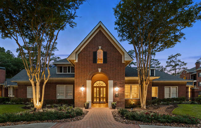 the front of a brick house with a walkway and trees at Villages of Cypress Creek, Texas, 77070