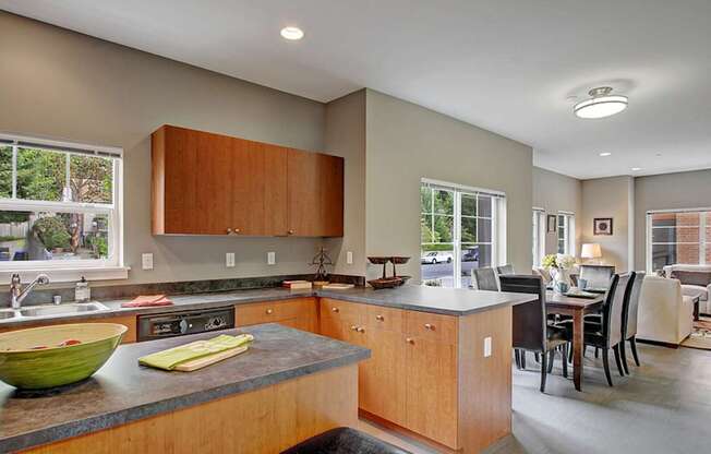 A kitchen with wooden cabinets and a green bowl on the counter.