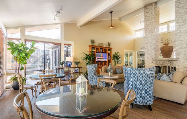 A living room with a glass table and chairs.