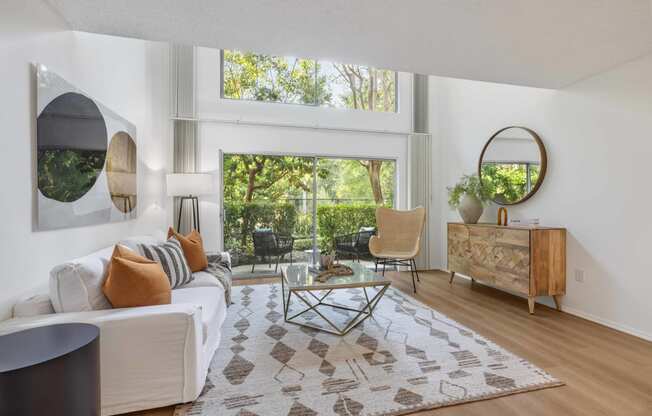 a living room with a white couch and a large window