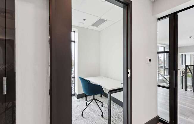 A room with a white table and a blue chair.