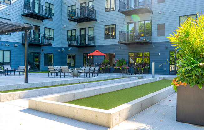 a grassy area in front of an apartment building