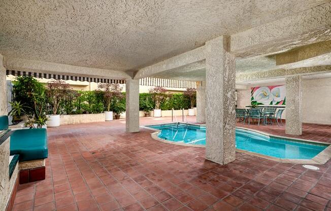 a swimming pool in the middle of a room with columns