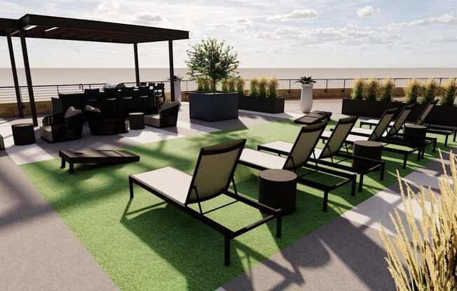 A patio with black furniture and a green lawn.