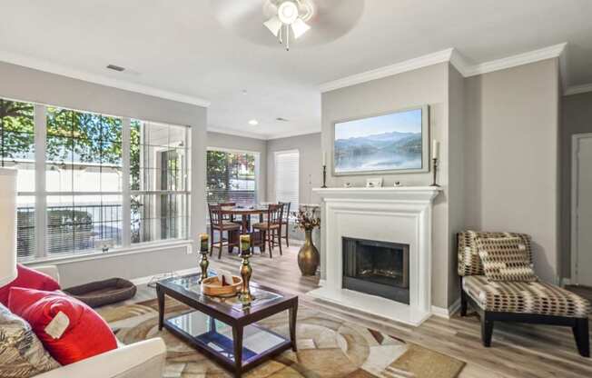 A living room with a fireplace and a painting on the wall.