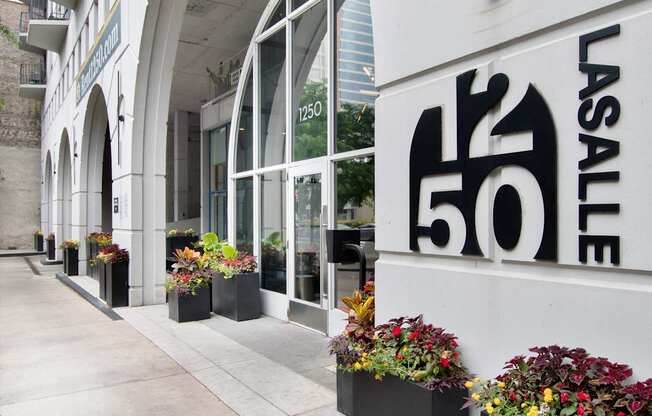 A white building with a black and white logo on the side.