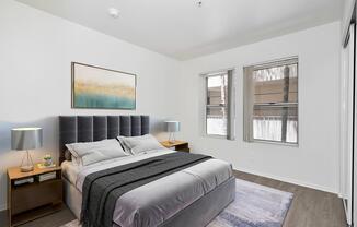 a bedroom with a bed and desk in a hotel room