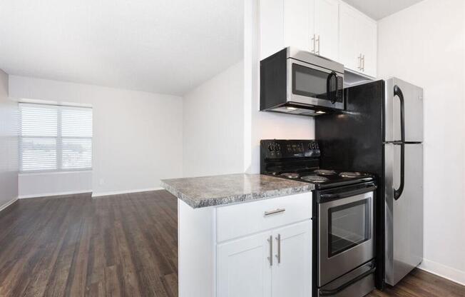 an empty kitchen with a stove refrigerator and microwave at Skyline Heights LLC, Daly City, CA