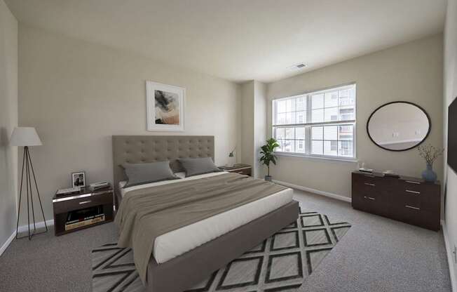 Bedroom with cozy bed and lamps at The Apartments at Owings Run, Owings Mills, MD