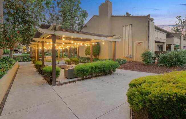 a patio with benches and a pavilion with lights at Summerwood Apartments, Santa Clara